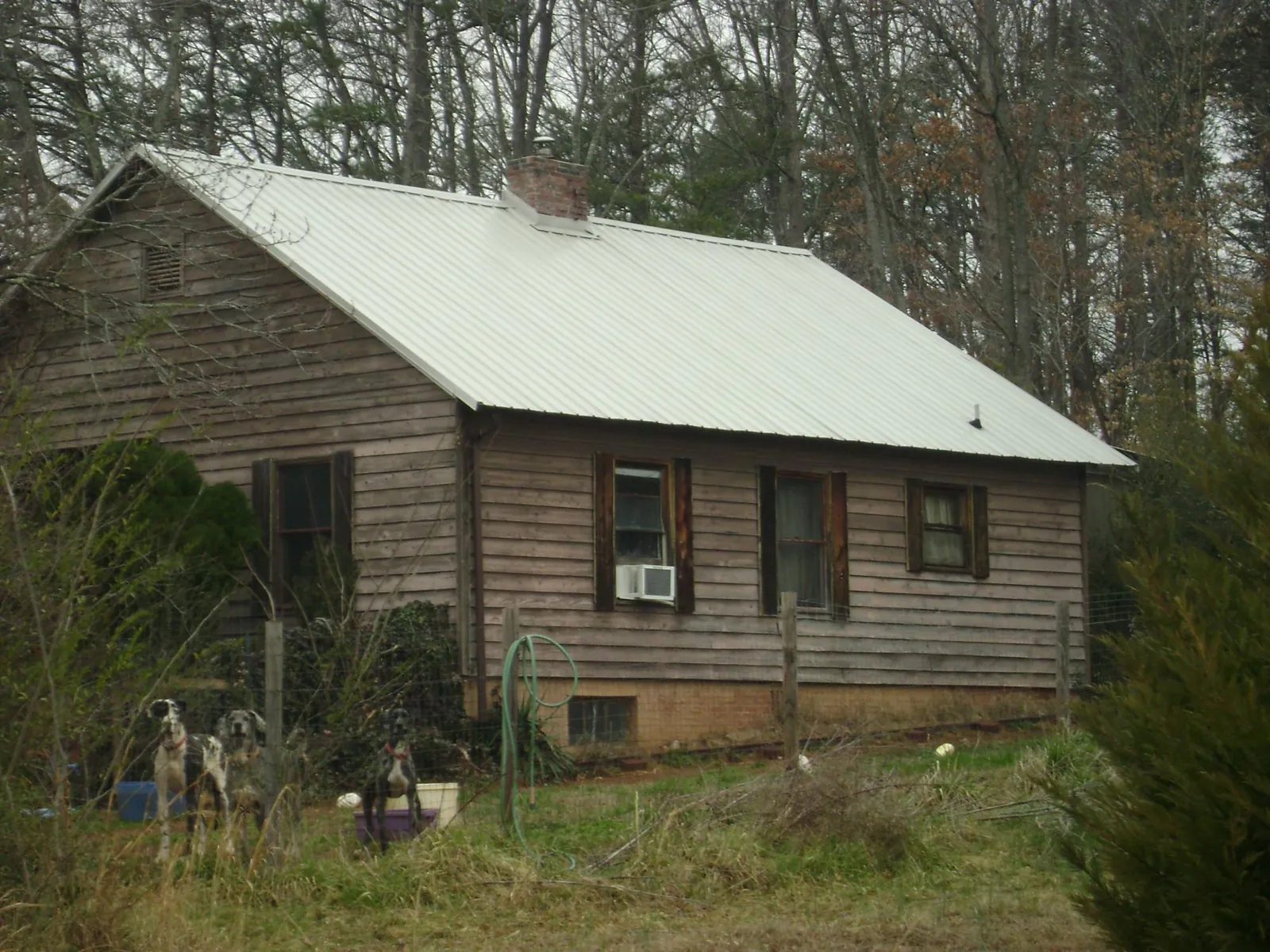 White metal roof on an old wood sided farmhouse, from a Metal Roof Installation job in Reynoldsburg
